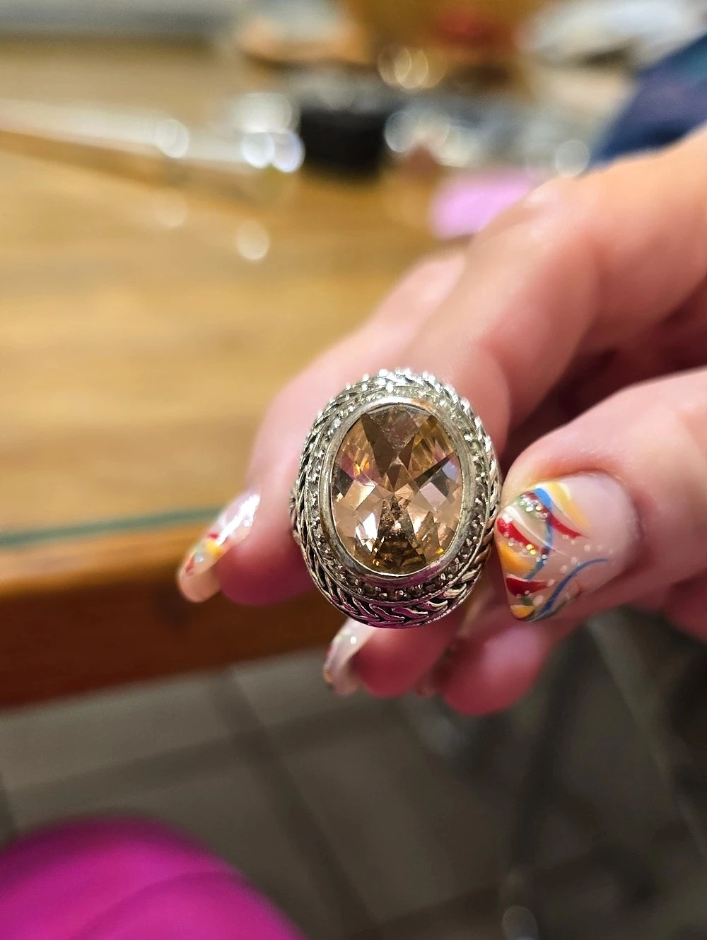 Ornate Sterling Silver ring Featuring a large Oval Peach Colored Gemstone.
